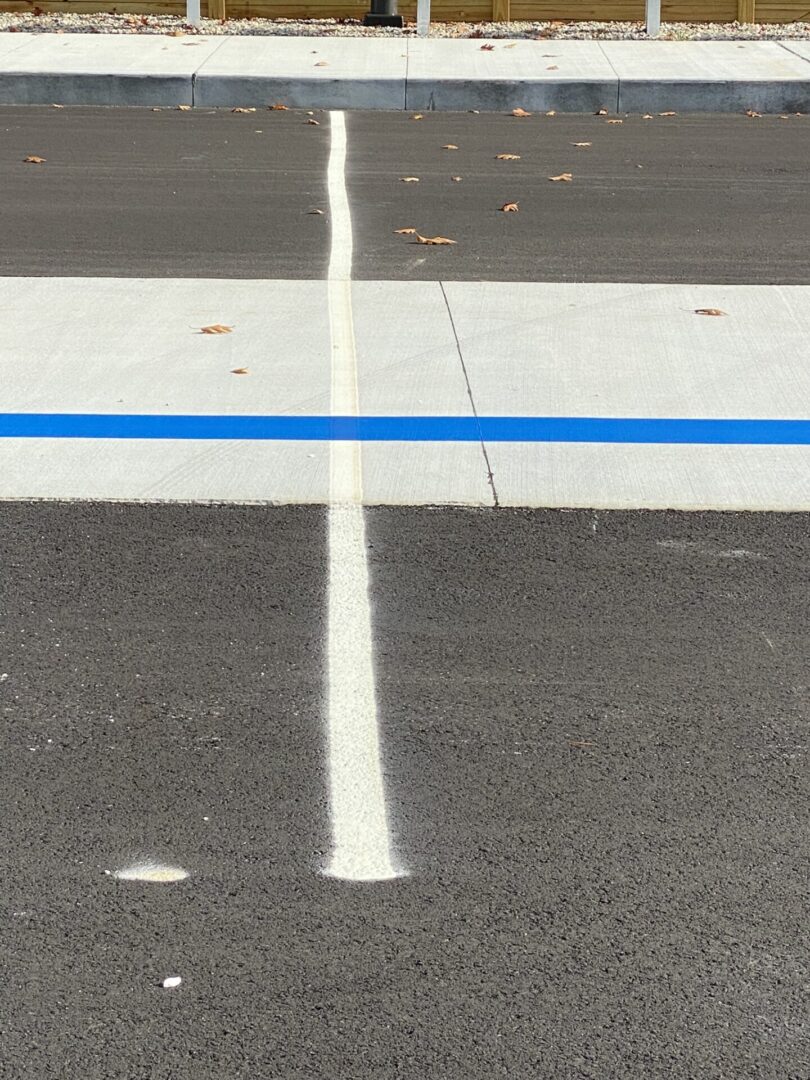 White and blue marking on plain road